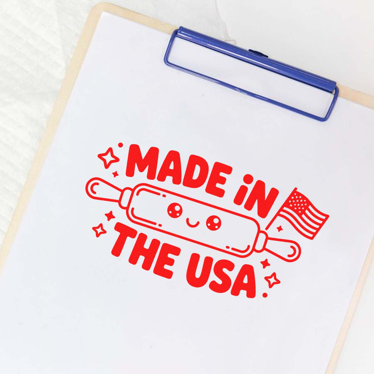 Made in the USA rubber stamp design with rolling pin and flag, printed on clipboard paper for patriotic packaging or branding.