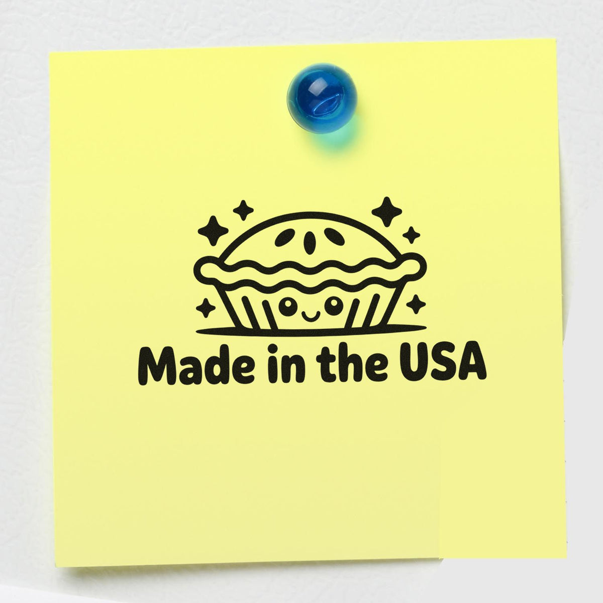 Made in the USA rubber stamp design on yellow sticky note with pie icon and blue push pin.