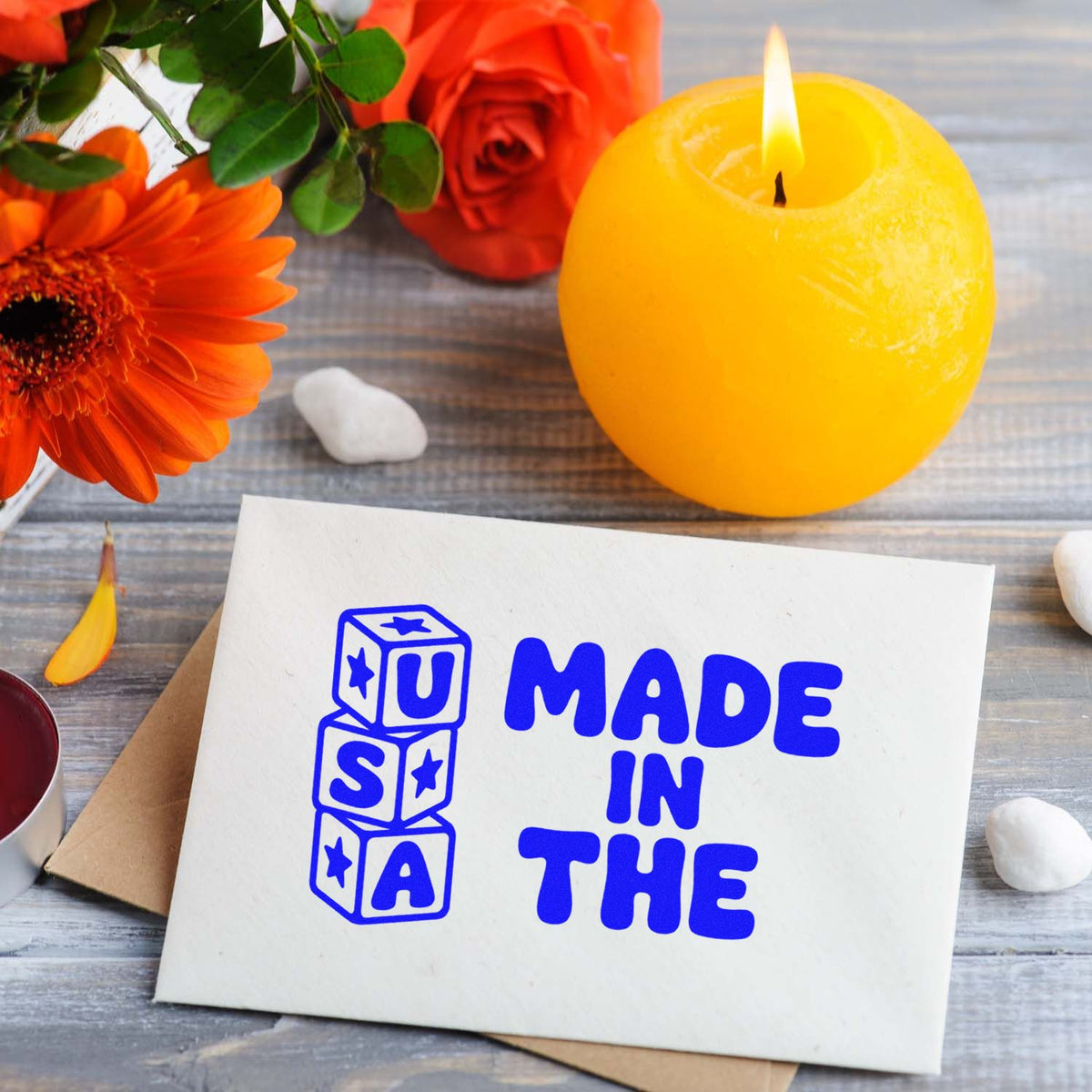 Made in the USA rubber stamp on a greeting card, styled with flowers and candle for patriotic handmade craft projects.