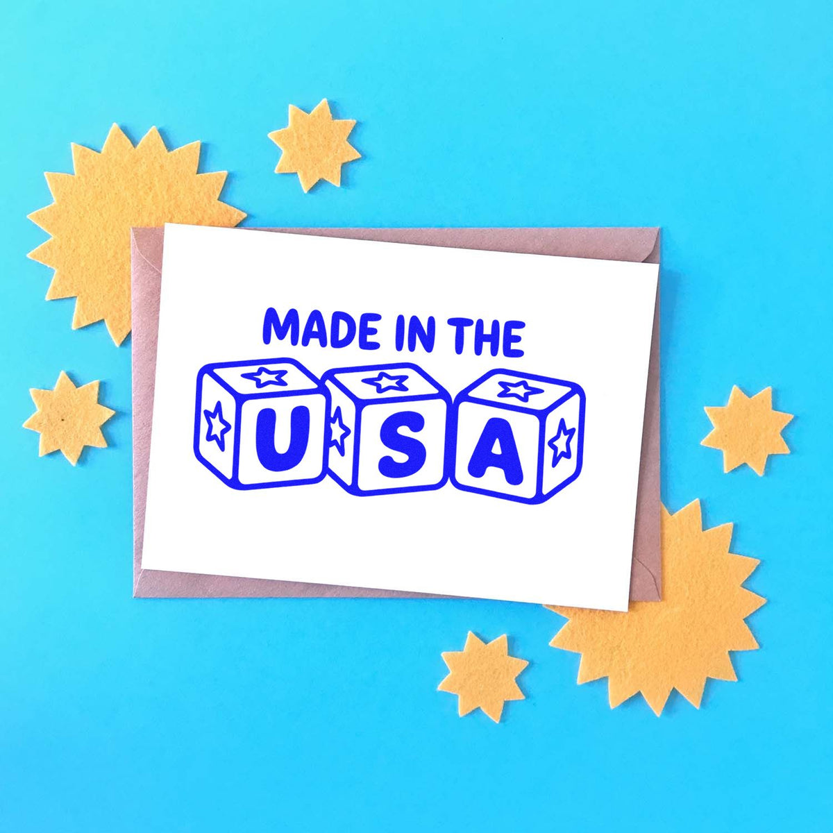 Made in the USA rubber stamp design on a card with patriotic star accents for handmade crafts and packaging.