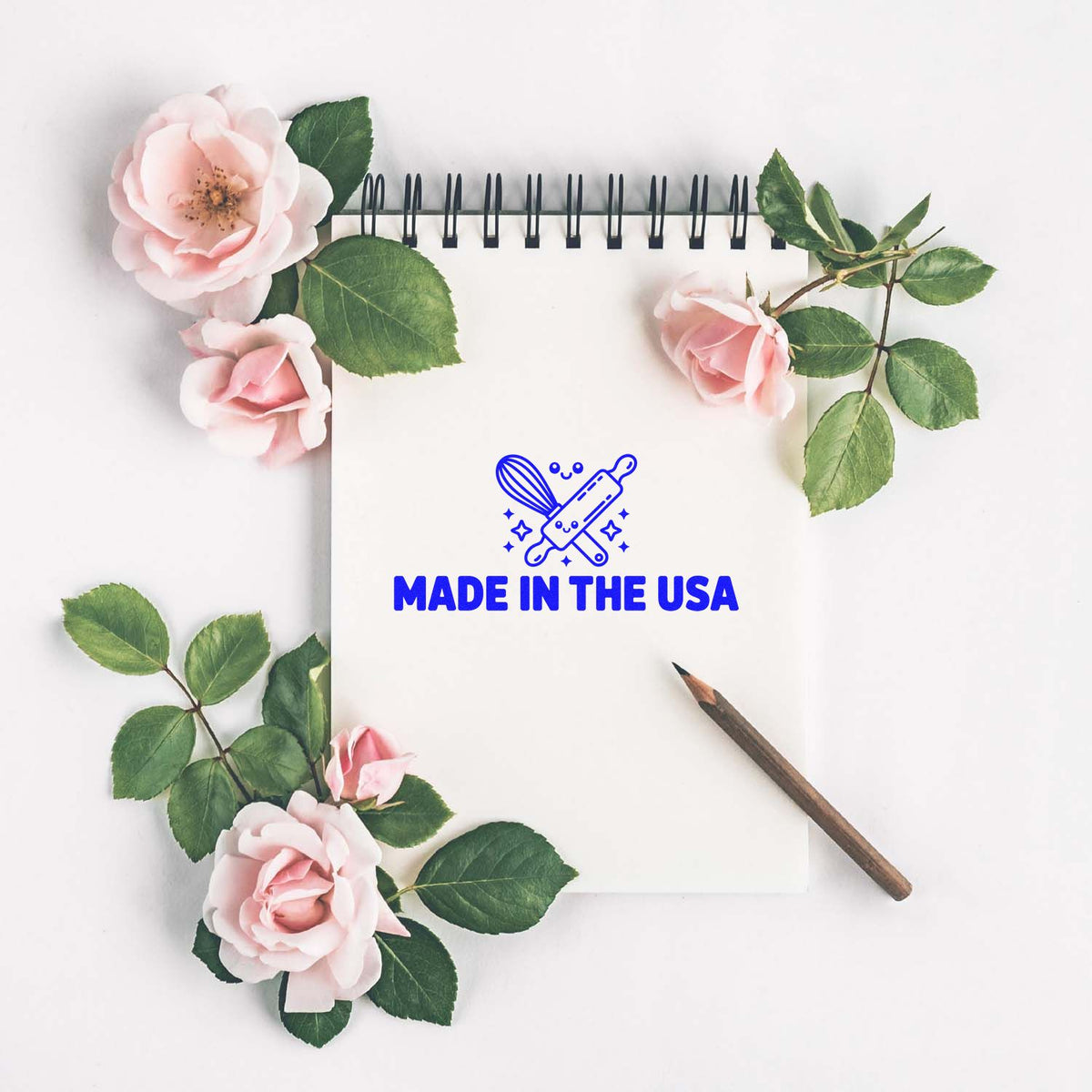Made in the USA rubber stamp impression on notebook, styled with roses and pencil for patriotic handmade branding.