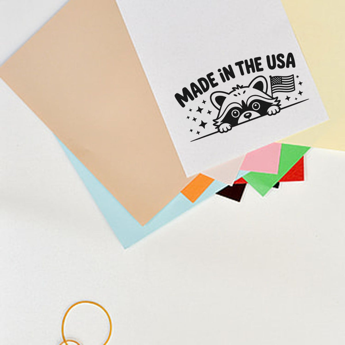 Made in the USA raccoon rubber stamp design on paper with American flag, ideal for custom packaging and craft projects.