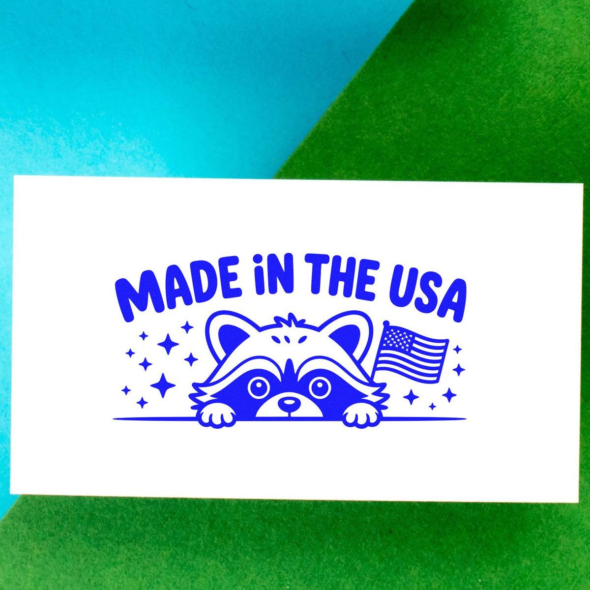 Made in the USA rubber stamp design with raccoon and American flag, ideal for patriotic custom stamping and packaging.