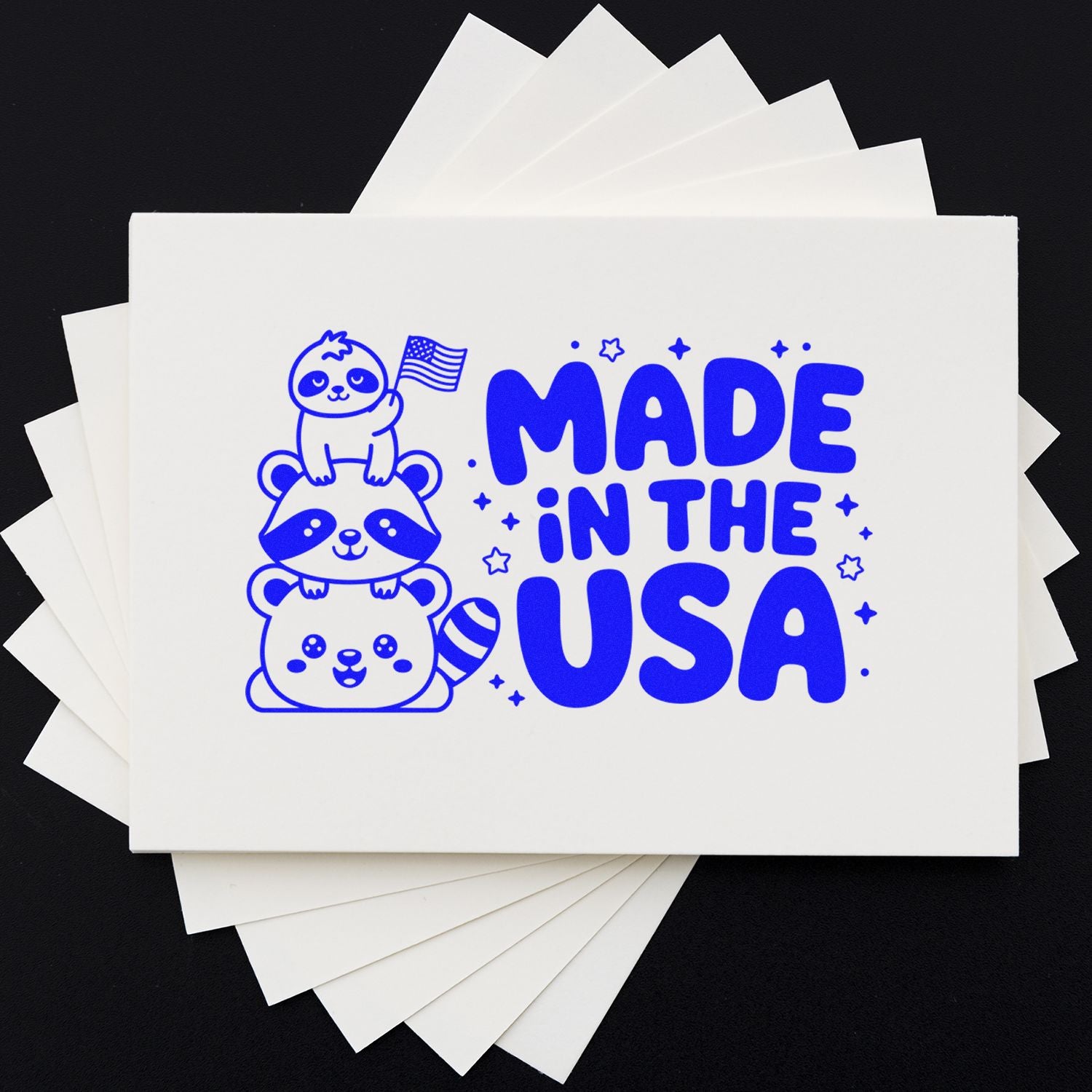 Made in the USA rubber stamp impression on white cards, featuring cute stacked animals and patriotic branding for packaging or crafts