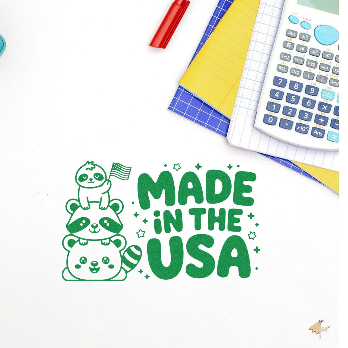 Made in the USA rubber stamp design with cute stacked raccoons and American flag, shown on a notebook with school supplies.