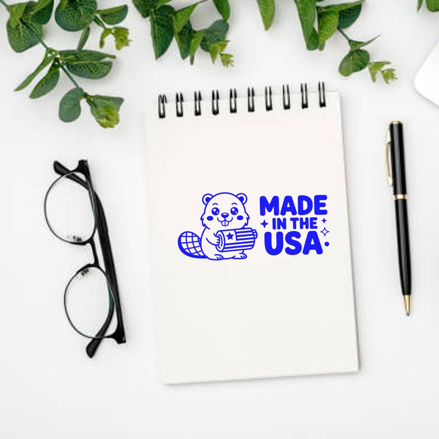 Made in the USA rubber stamp mockup on notepad with pen and glasses, ideal for branding handcrafted products and packaging.