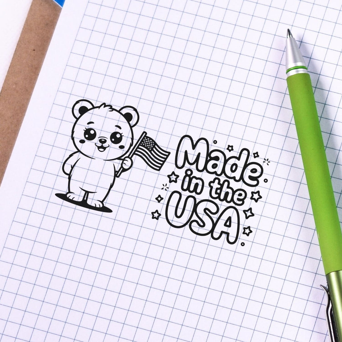 Made in the USA rubber stamp with cute bear holding an American flag, ideal for patriotic packaging, stationery, and crafts.