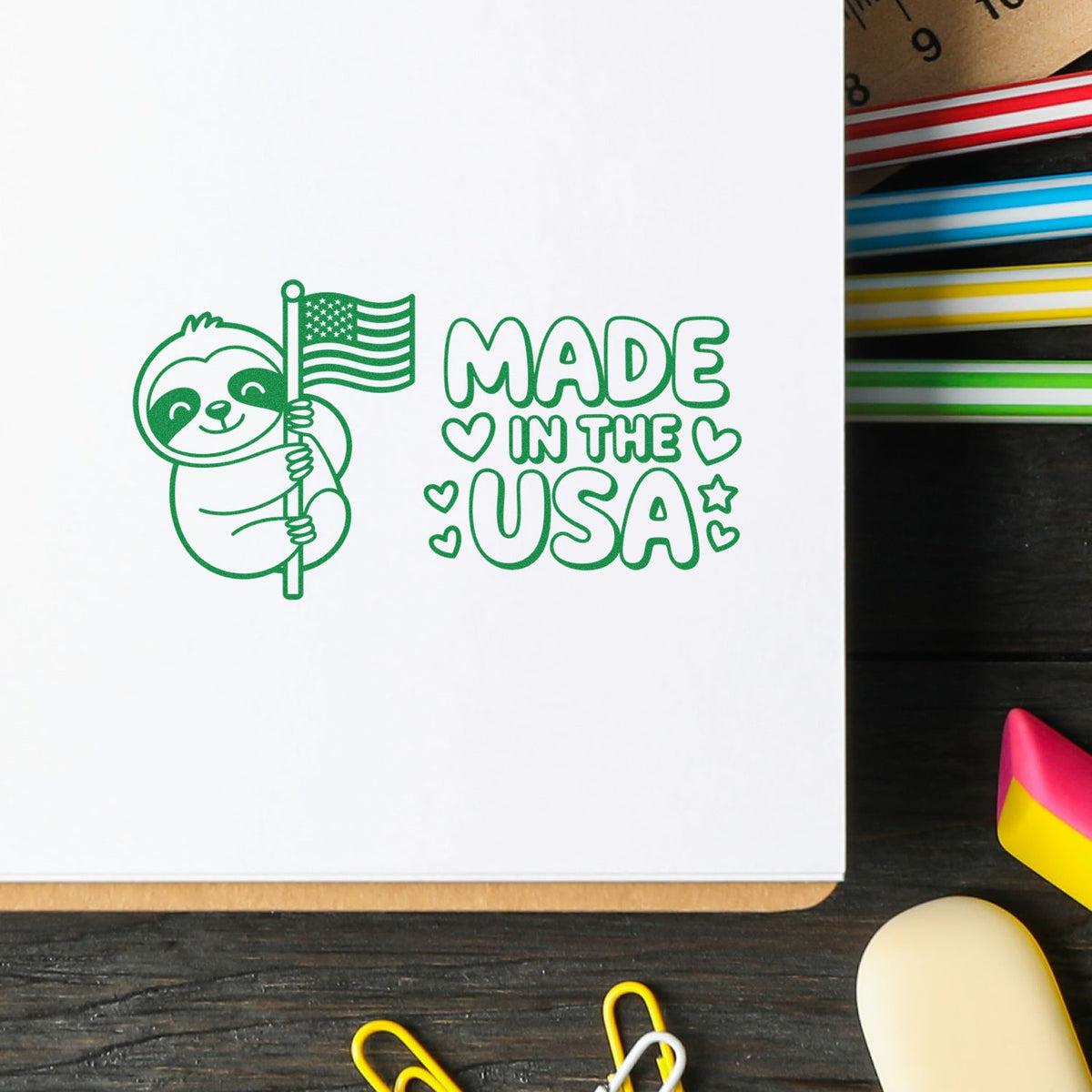 Made in the USA rubber stamp with sloth holding an American flag, ideal for handmade crafts and patriotic packaging.