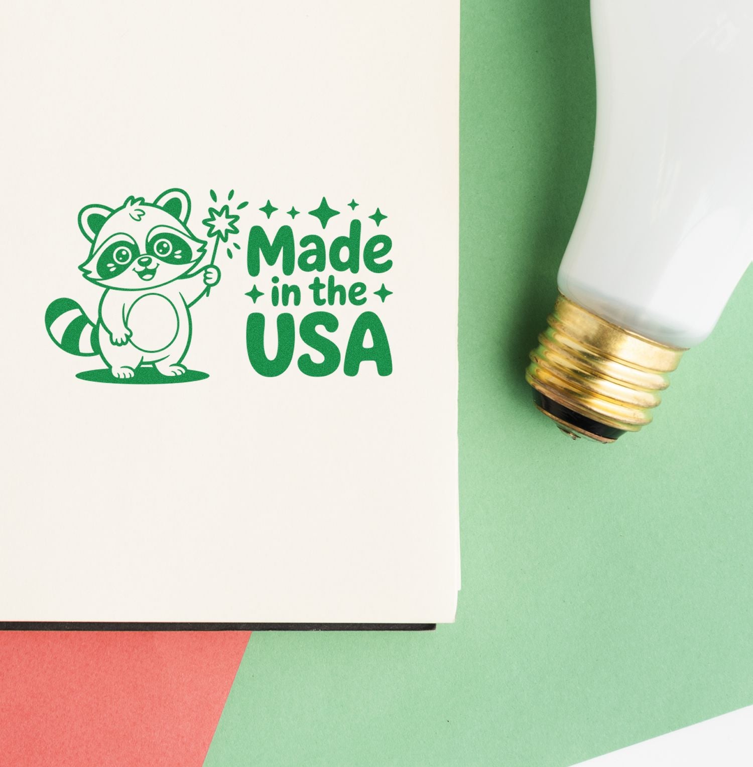 Made in the USA rubber stamp design with raccoon mascot and wand, shown stamped in green on paper.