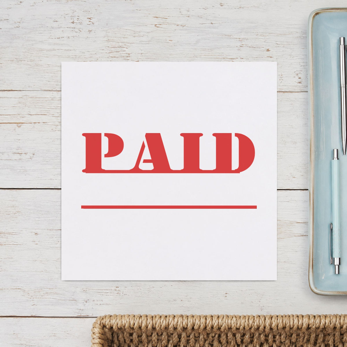 "Paid" mark added to paperwork with a pre-inked Xstamper stamp