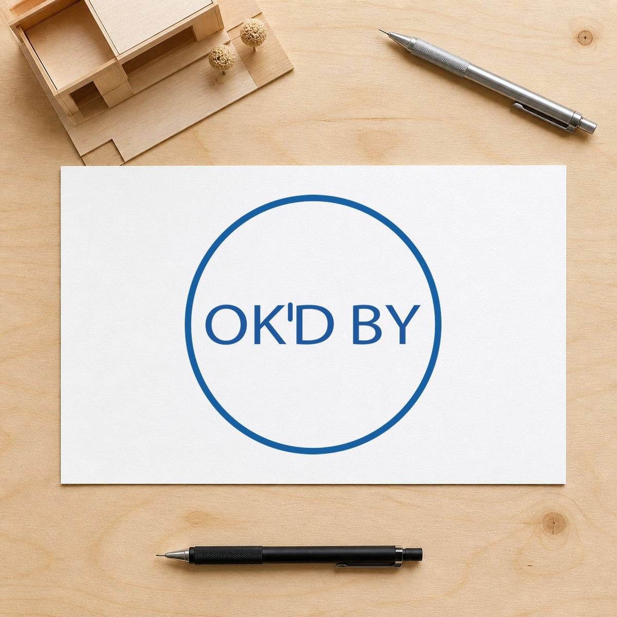 "OK'd by" imprint stamped on a document with the Xstamper OK'd By Approval Stamp – Round Pre-Inked