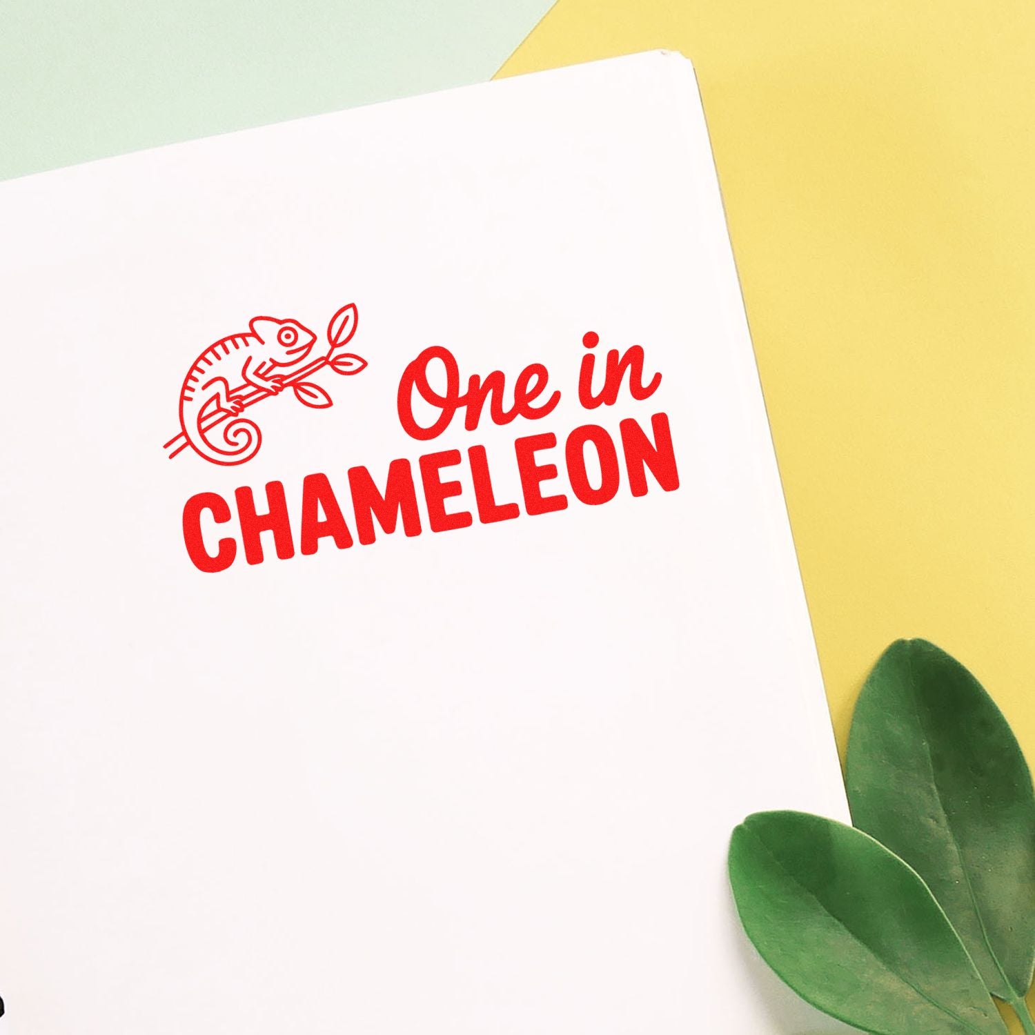 Custom rubber stamp design reading One in Chameleon with chameleon icon for wildlife-themed stationery.