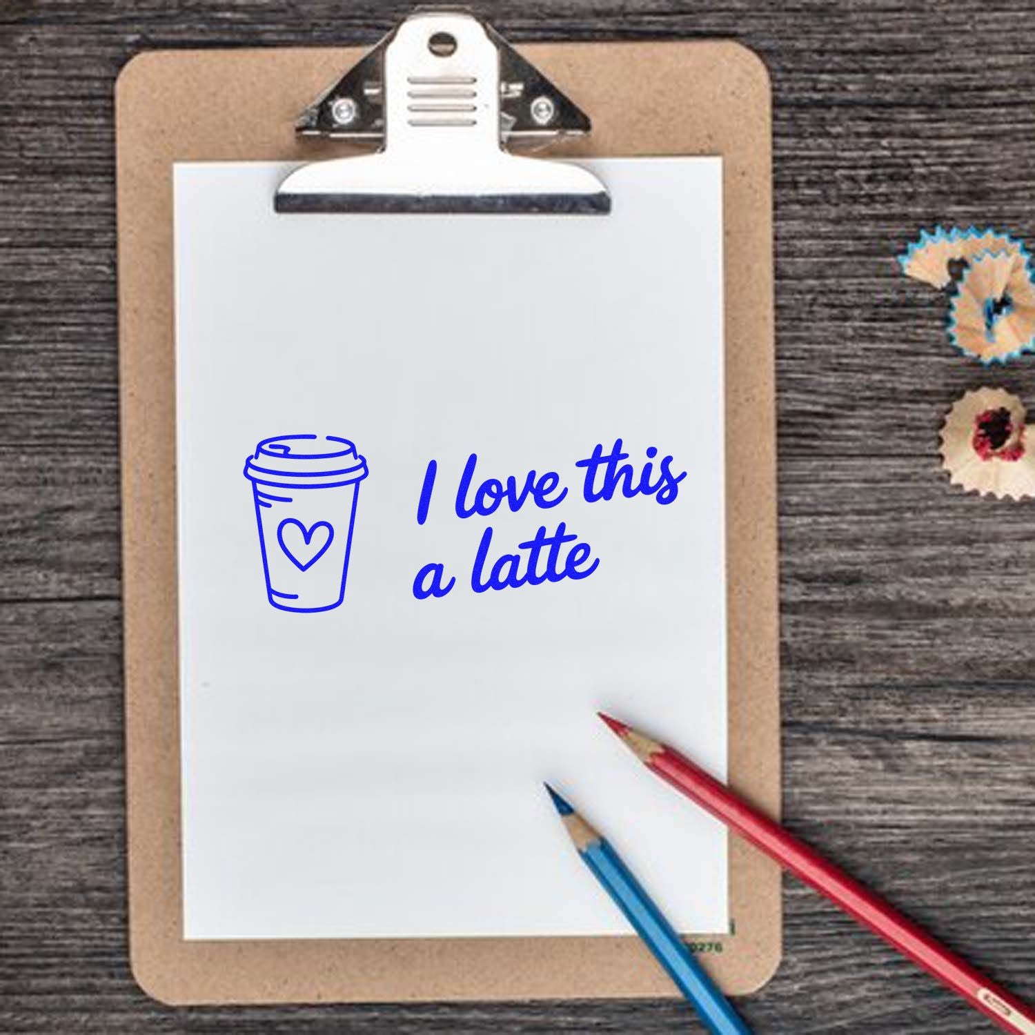 Coffee-themed rubber stamp design with "I love this a latte" text and cup icon on clipboard for crafting and stationery.