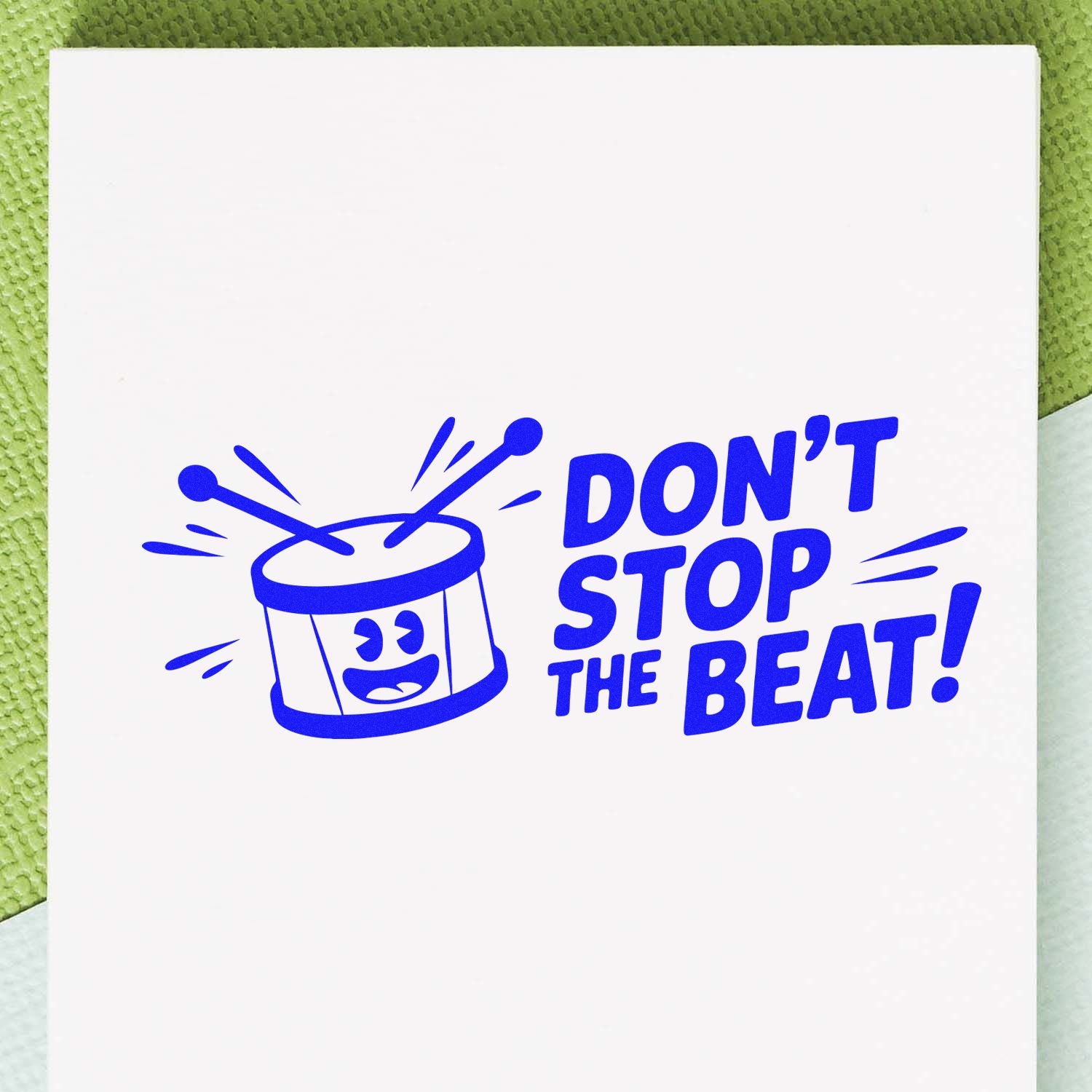 Blue rubber stamp design featuring a drum graphic and Dont Stop the Beat! text for music-themed crafts.