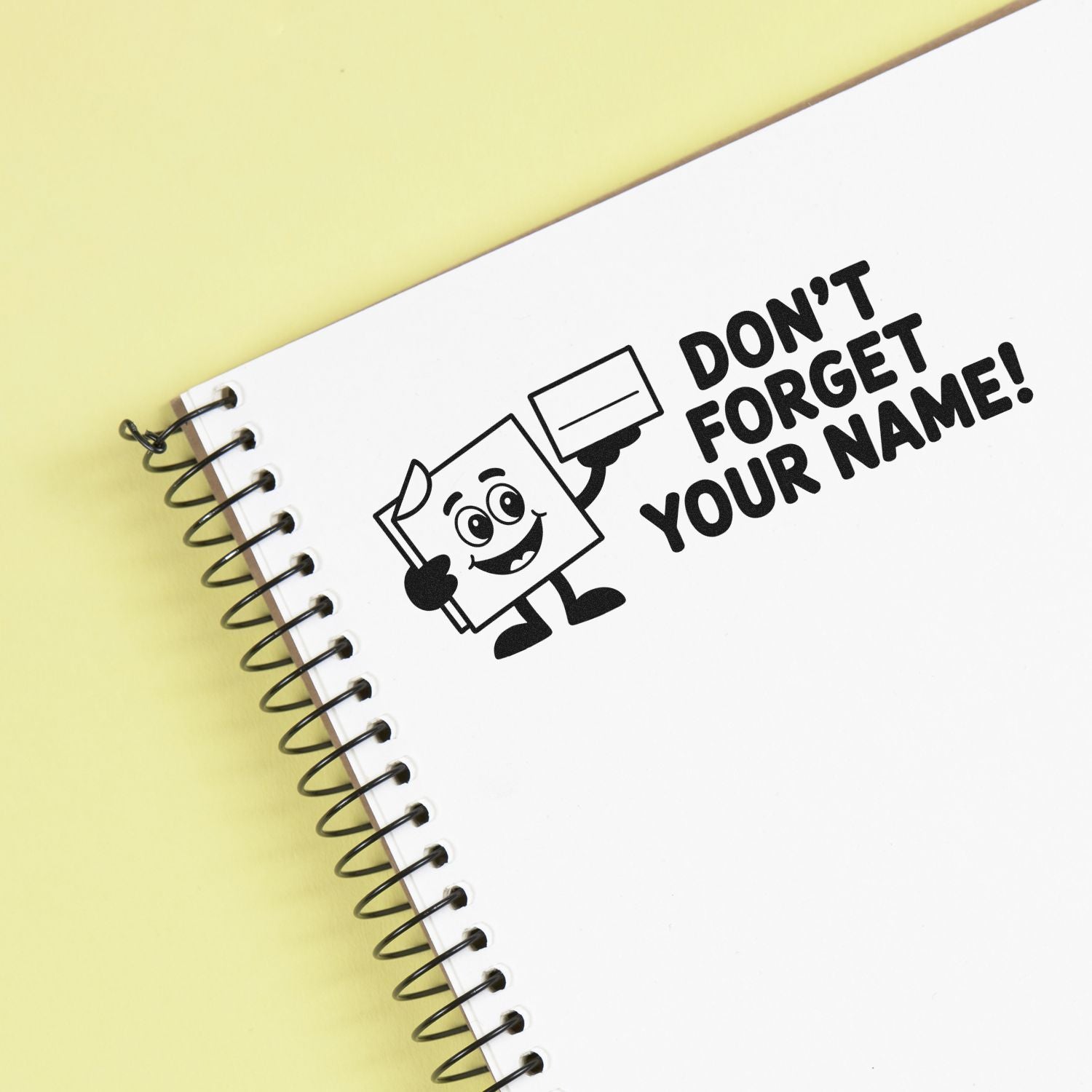 Custom rubber stamp design saying Dont Forget Your Name! for notebooks, school supplies, and personal labeling.