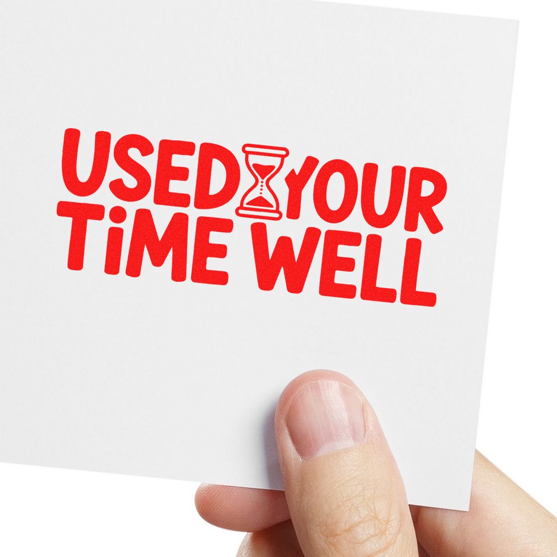 Red Used Your Time Well rubber stamp design with hourglass icon, shown on a white card held in hand.