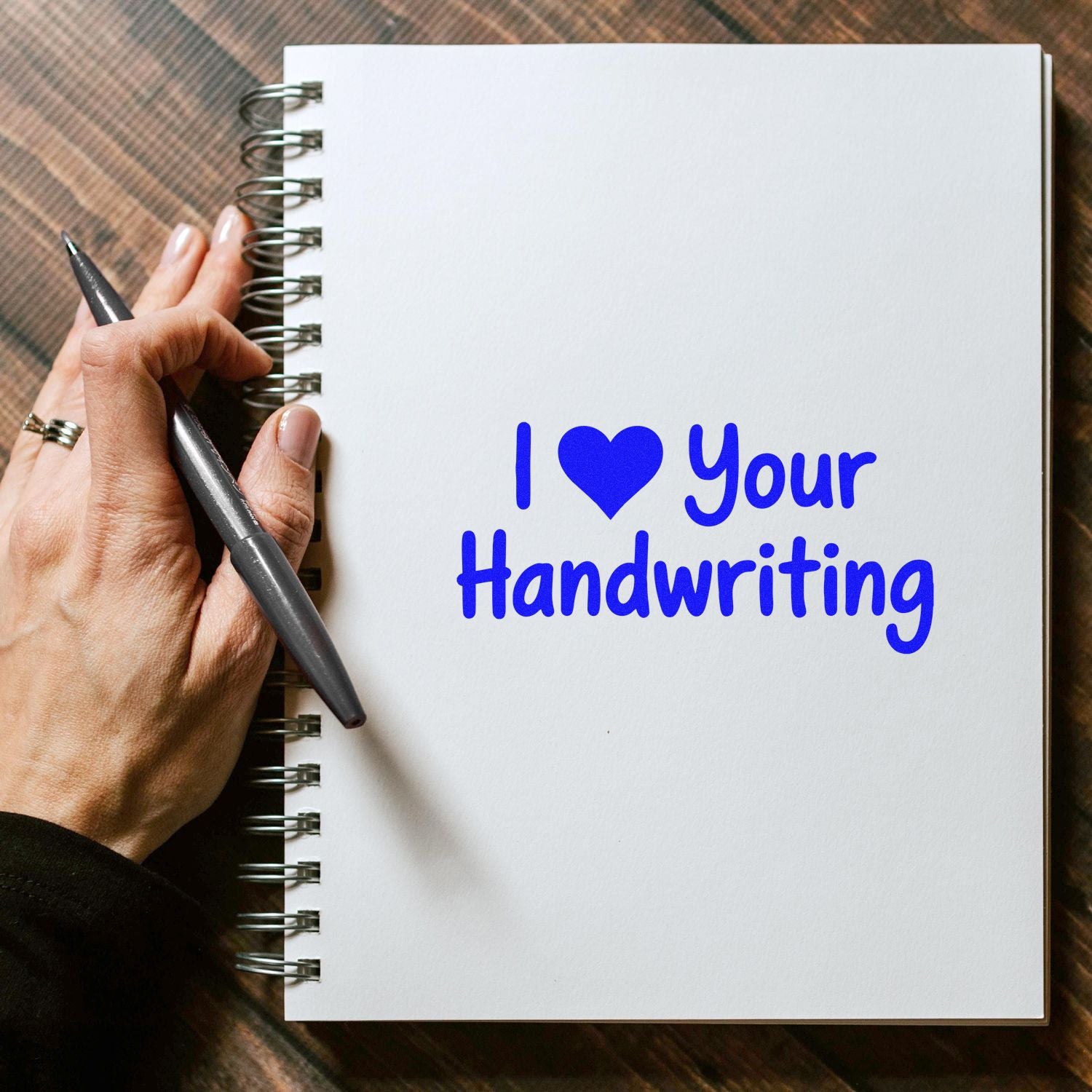 Blue rubber stamp saying I Love Your Handwriting on a notebook page, perfect for journaling, cards, and craft projects.