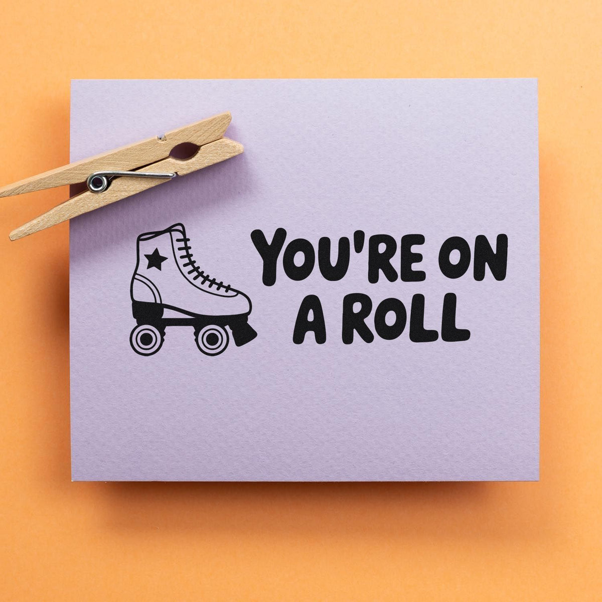 Roller skate rubber stamp design reading Youre on a Roll for DIY stationery, craft projects, and inspirational cards.