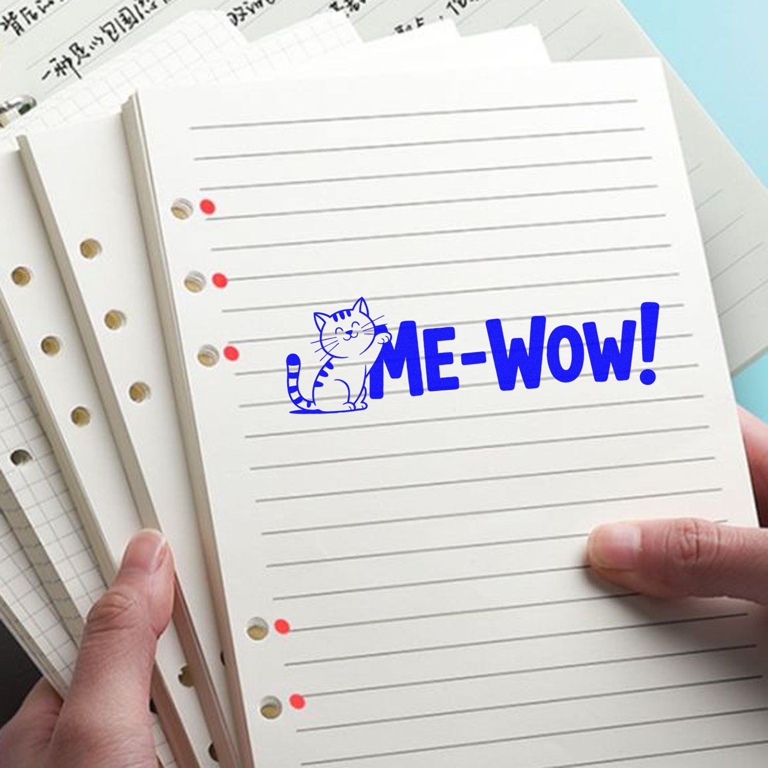 Blue cat rubber stamp with ME-WOW! on lined notebook paper, ideal for journals, planners, and cute stationery projects.