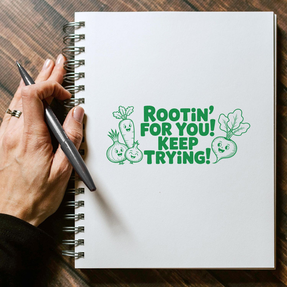 Custom rubber stamp with encouraging vegetable design on notebook says Rootin for you! Keep trying! for planners and journals.