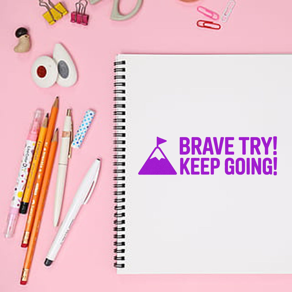 Motivational rubber stamp on notebook reading Brave Try! Keep Going! for journaling, classroom rewards, or encouraging stationery.