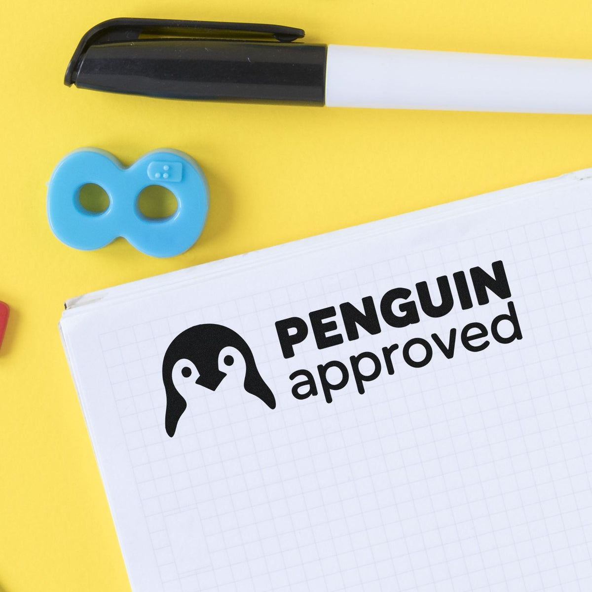 Penguin Approved rubber stamp with marker and notebook, ideal for custom office approval and branding stamps.