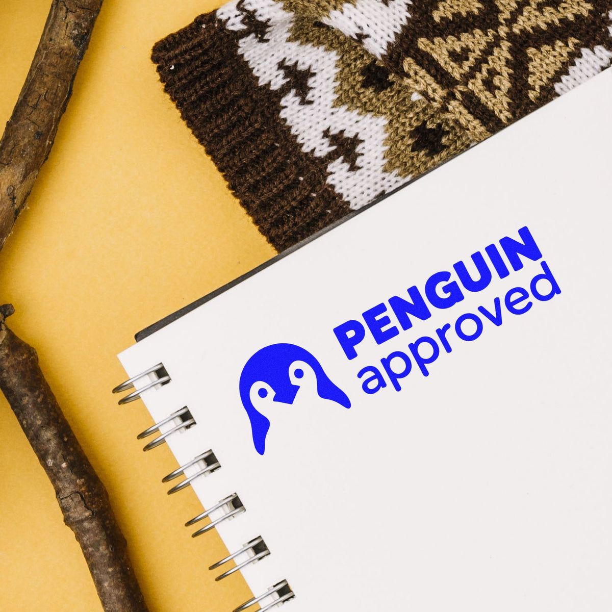 Penguin Approved custom rubber stamp logo on notebook, ideal for branded stationery and packaging.