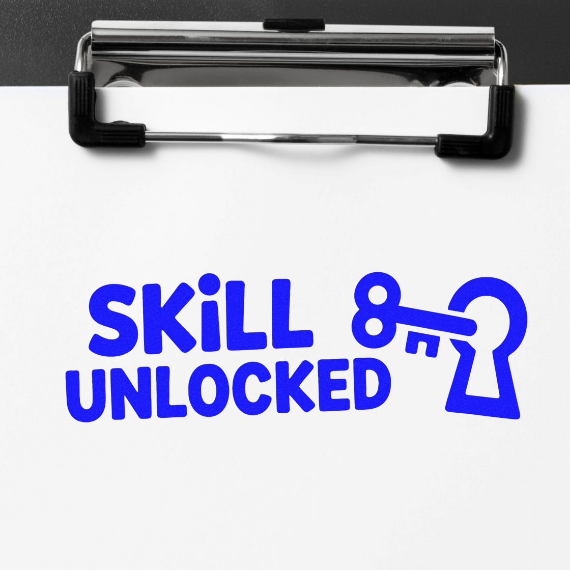 Custom rubber stamp impression reading Skill Unlocked with key and keyhole icon on white paper.