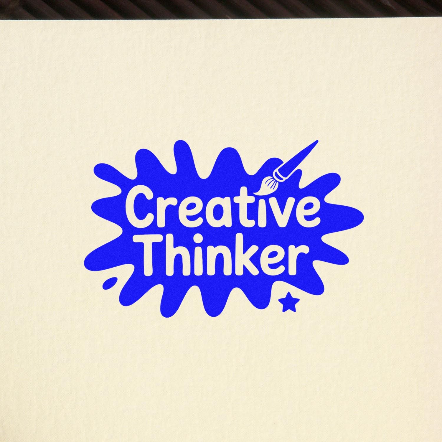 Creative Thinker rubber stamp design with blue paint splat, brush icon, and star for arts and crafts projects.