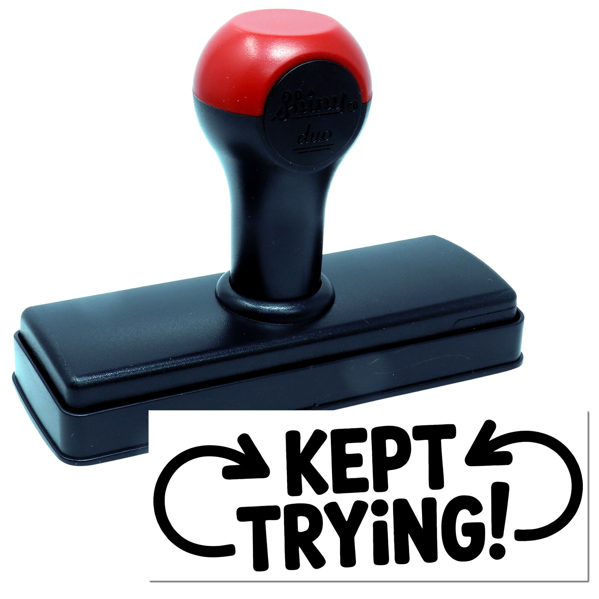 Self-inking rubber stamp with Kept Trying! motivational imprint for custom office or classroom messaging.