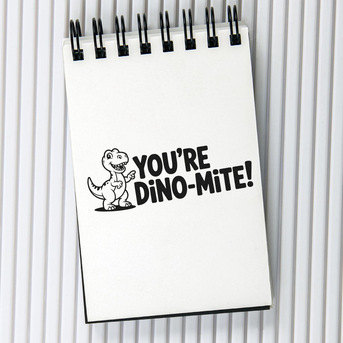 Funny dinosaur rubber stamp design reading Youre Dino-mite! for playful greeting cards, classroom crafts, and scrapbooking.