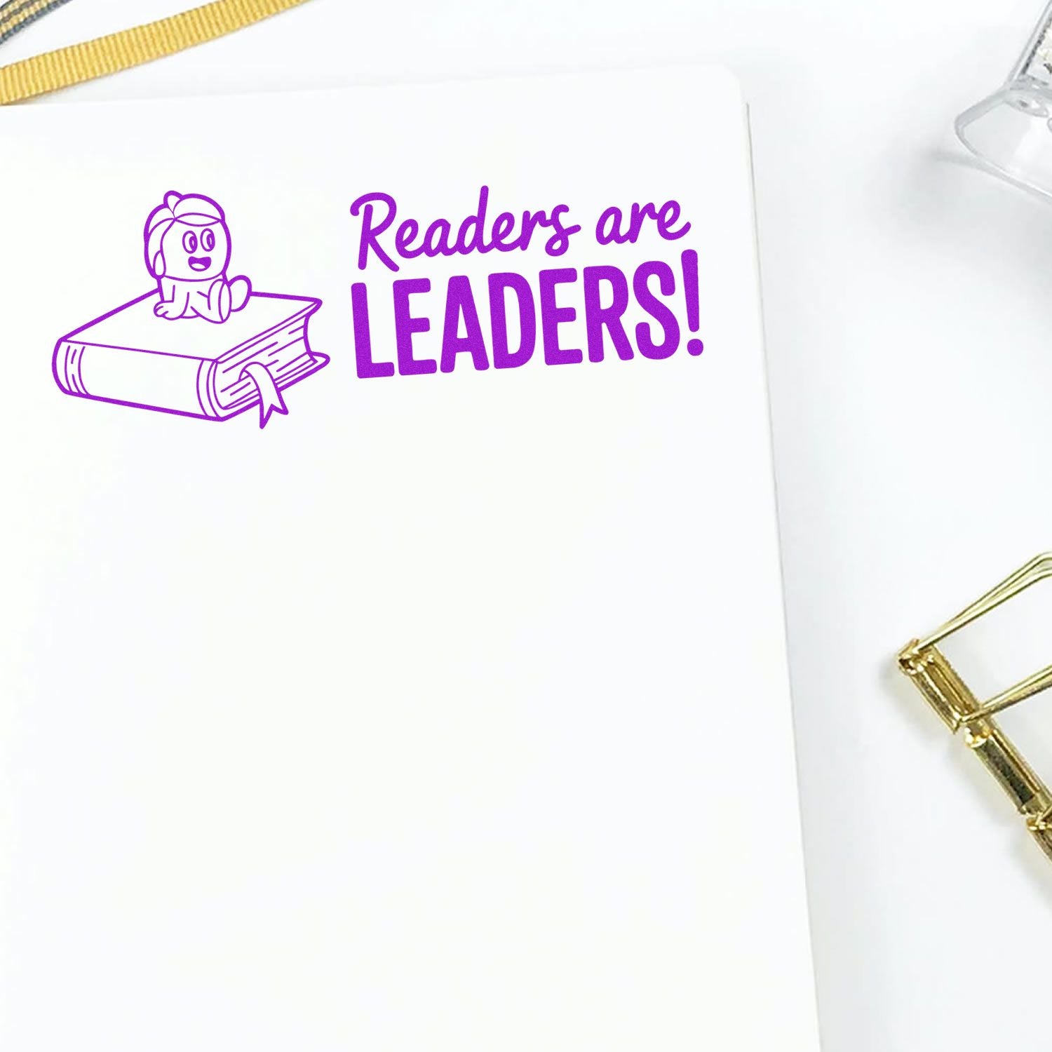 Purple Readers Are Leaders rubber stamp with child reading on a book, ideal for classroom, library, and literacy promotions.