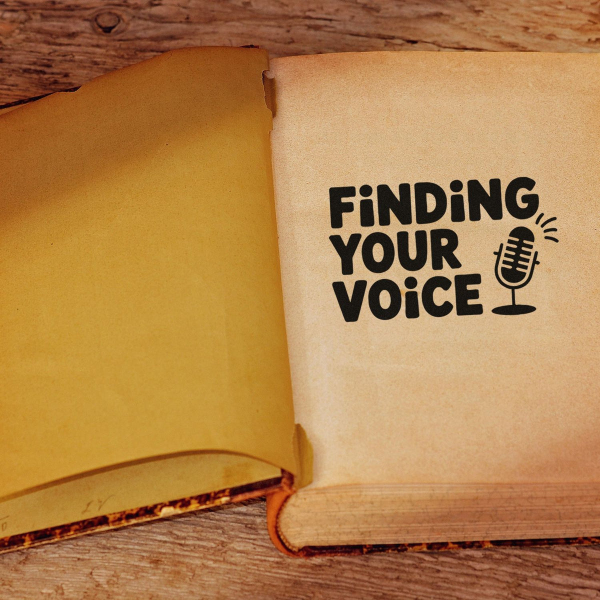 Open book featuring a Finding Your Voice custom rubber stamp design with microphone icon, ideal for journaling and podcast branding.