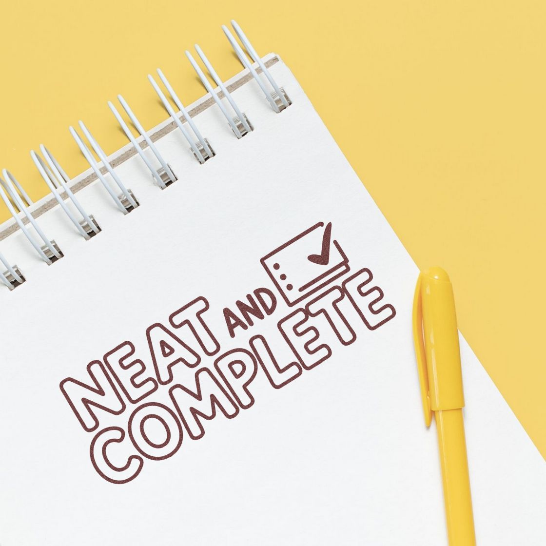 Neat and Complete rubber stamp graphic on a notebook with checkmark, ideal for document approval and organization.