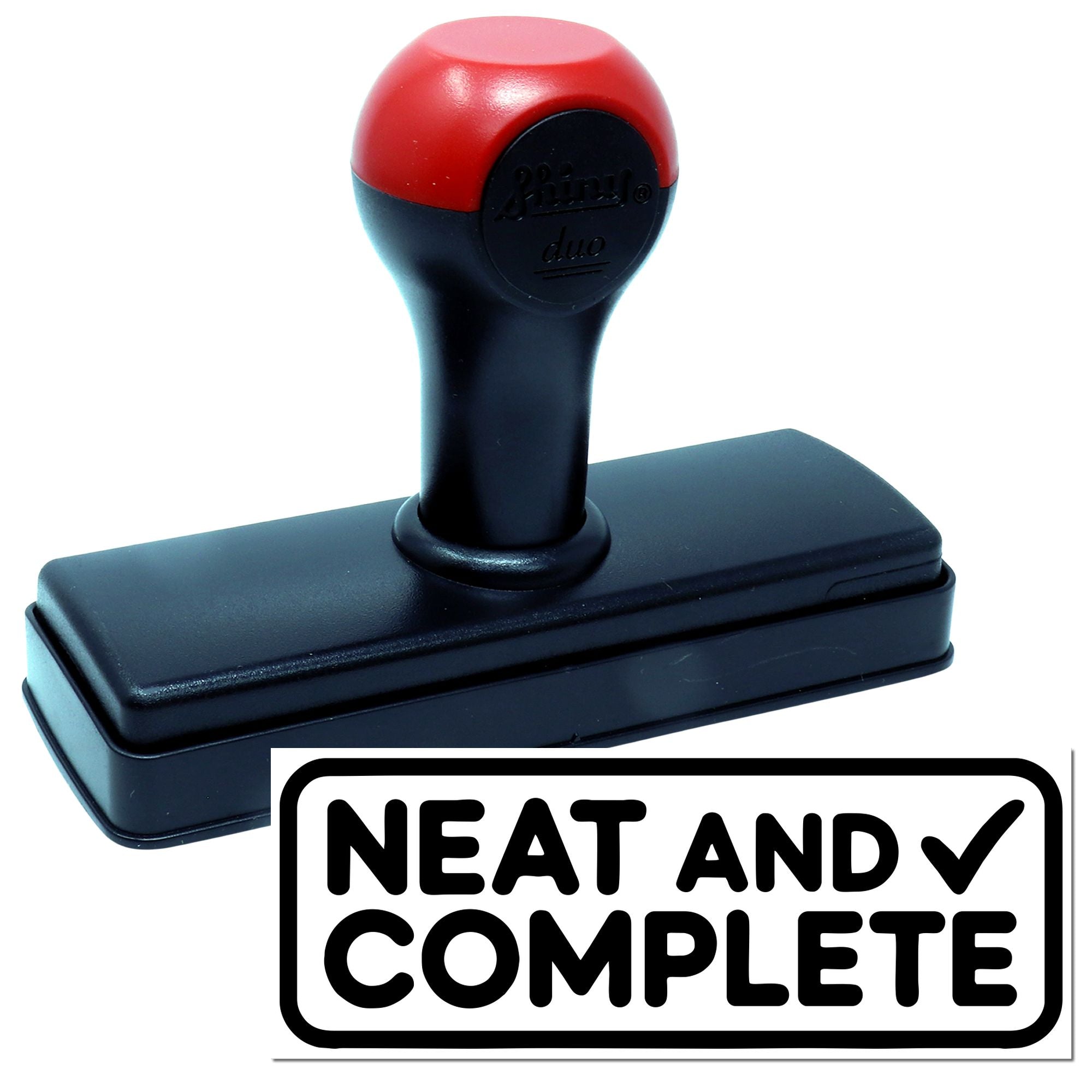Self-inking rubber stamp with red and black handle, designed for crisp Neat and Complete office imprint.