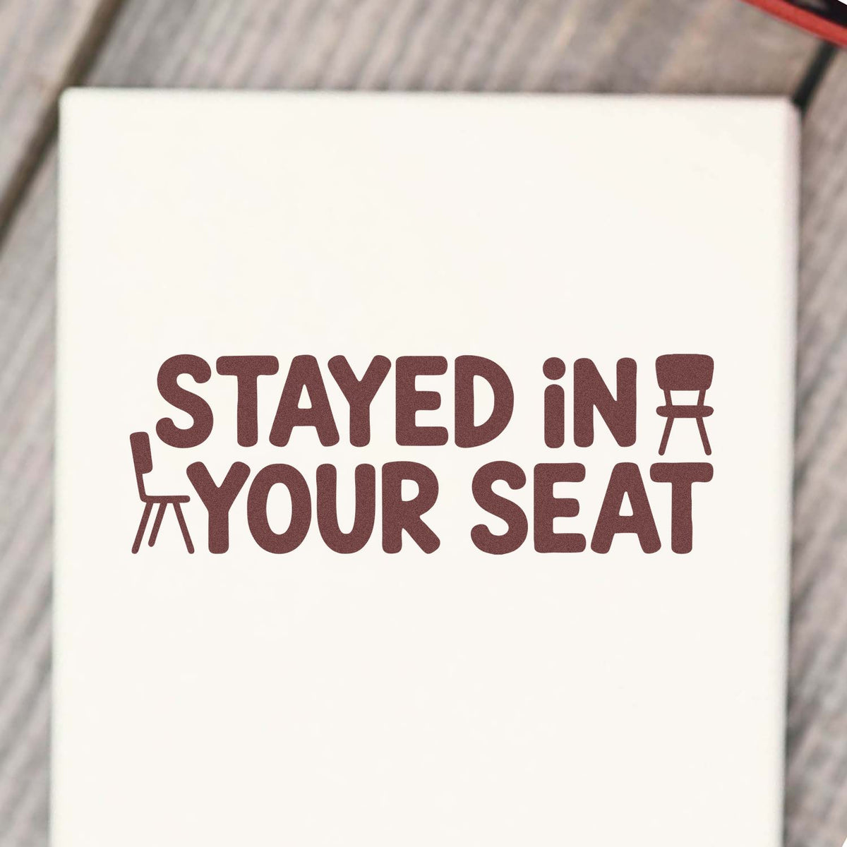Stay in your seat rubber stamp design with bold text and chair icons for classroom, office, or event use.