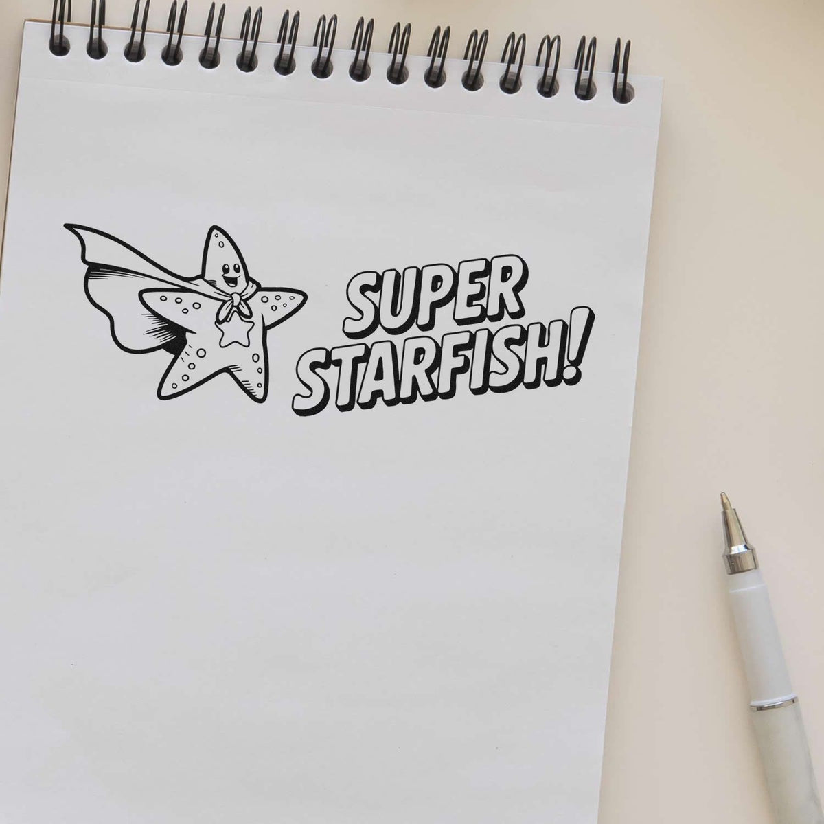 Super Starfish rubber stamp sample on notebook paper, ideal for ocean-themed crafts, planners, and card making.
