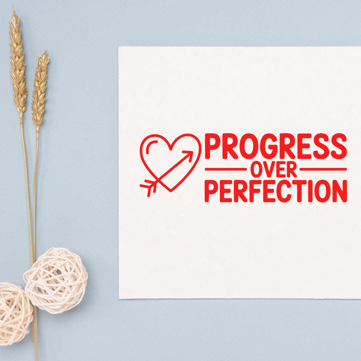 Progress over Perfection rubber stamp design with heart arrow icon, promoting handmade card making and mindful crafting.