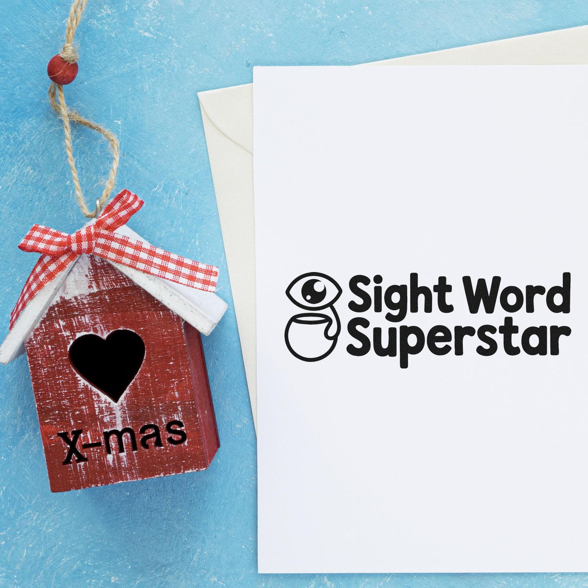 Custom rubber stamp design: Christmas birdhouse with heart cutout and Sight Word Superstar logo.