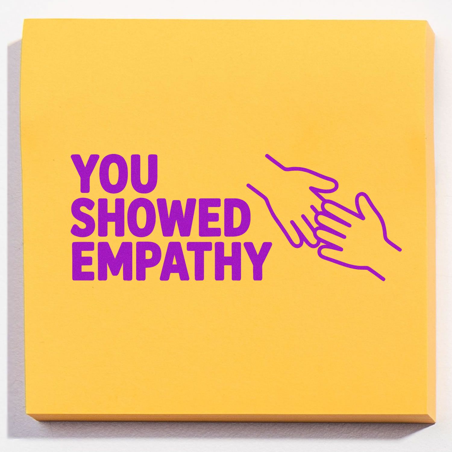 You showed empathy rubber stamp design with purple handshake icon on yellow background for recognizing compassionate actions.