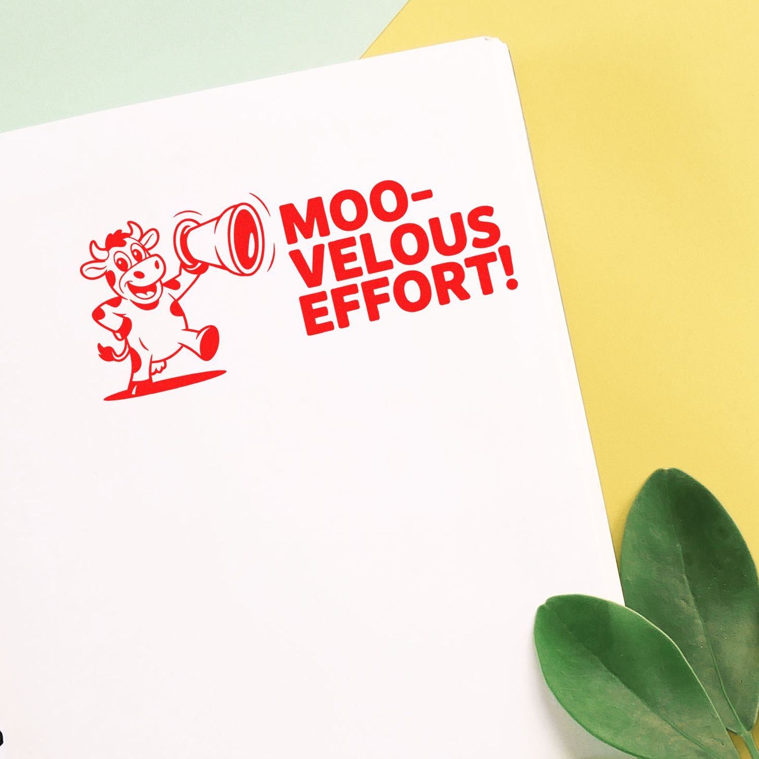 Red rubber stamp design with cow and megaphone reading Moo-velous Effort! for motivational crafting