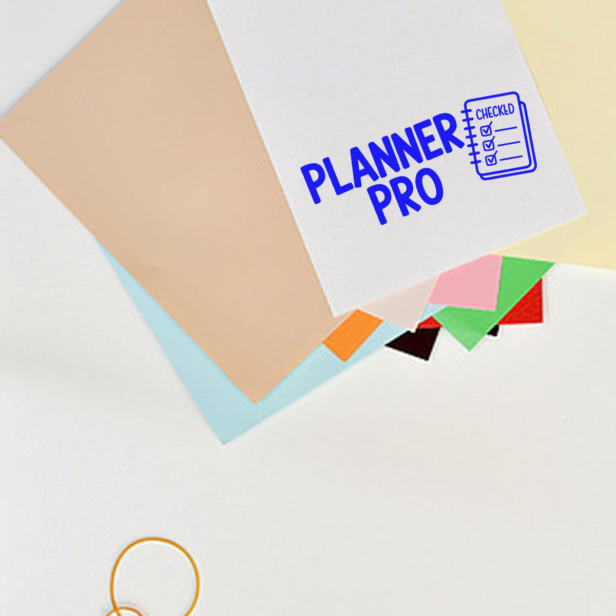 Blue Planner Pro rubber stamp with checklist icon on paper, perfect for organizing planners and marking tasks complete.