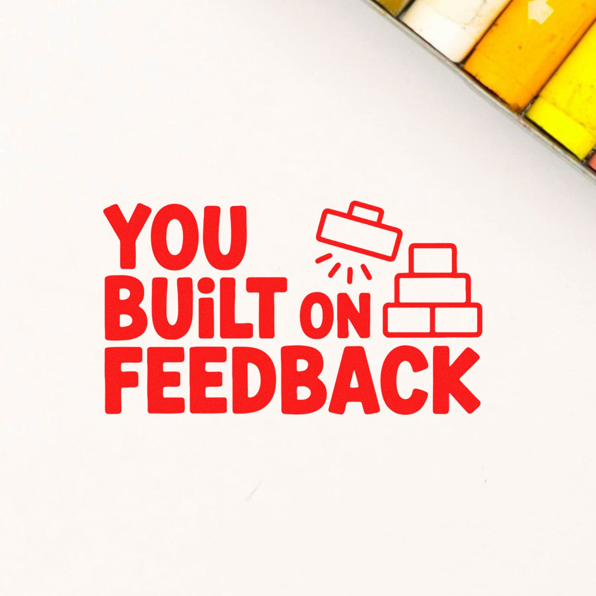 Custom rubber stamp design reading "You Built on Feedback" with block and stamp icons for business feedback messaging.