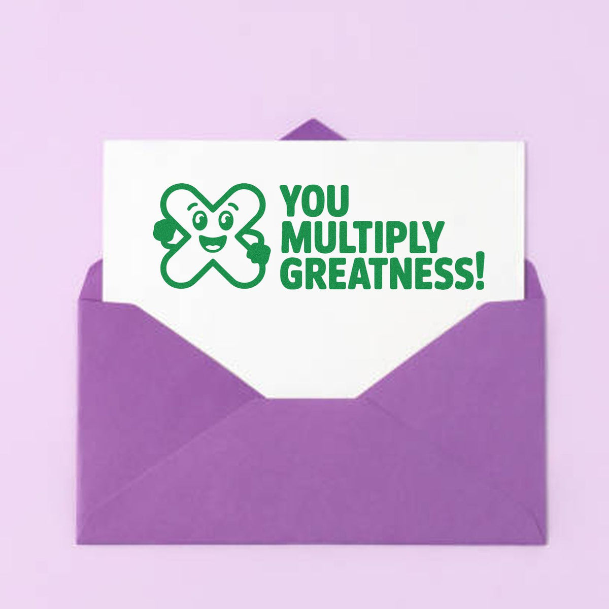Motivational rubber stamp reading You Multiply Greatness! on a card in a purple envelope.