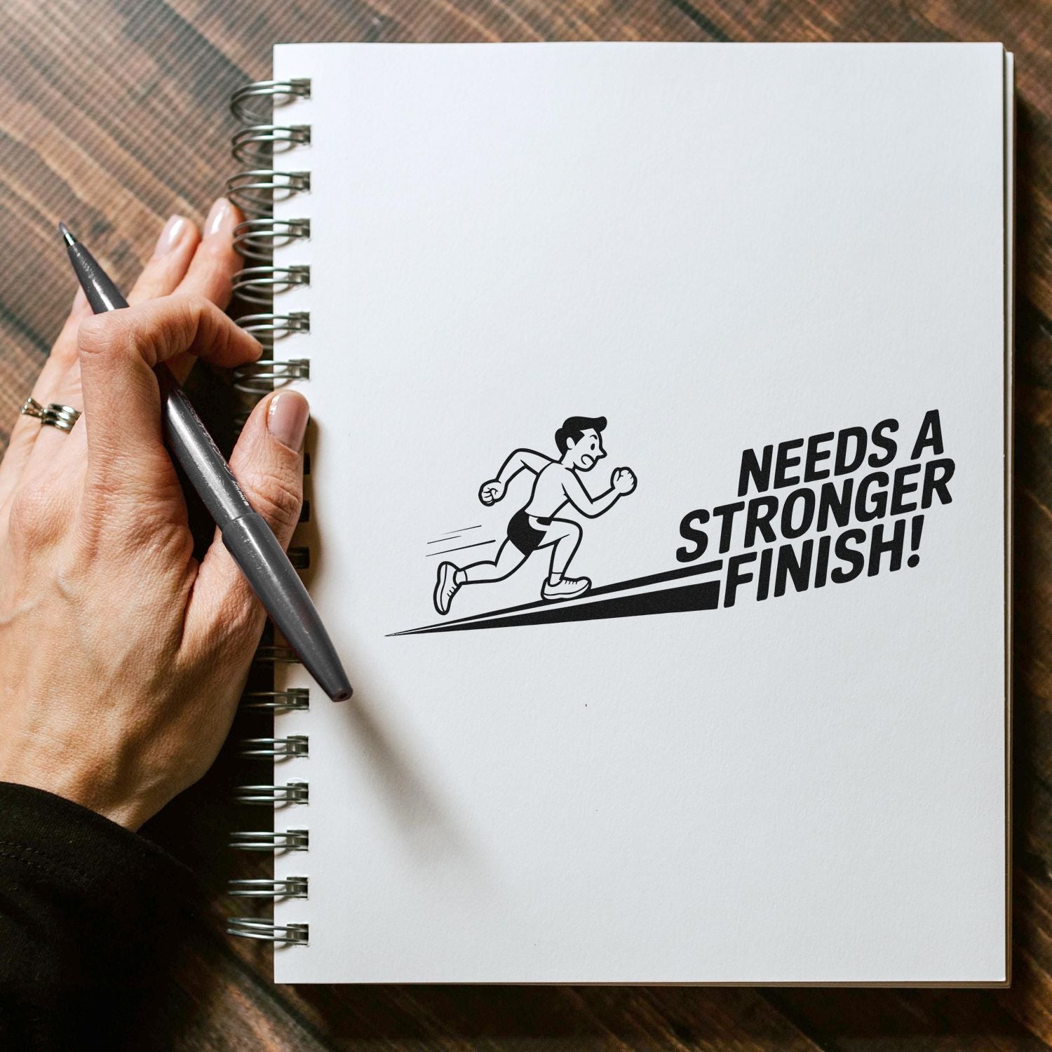Custom rubber stamp mockup with runner and Needs a Stronger Finish! slogan, ideal for fitness branding.