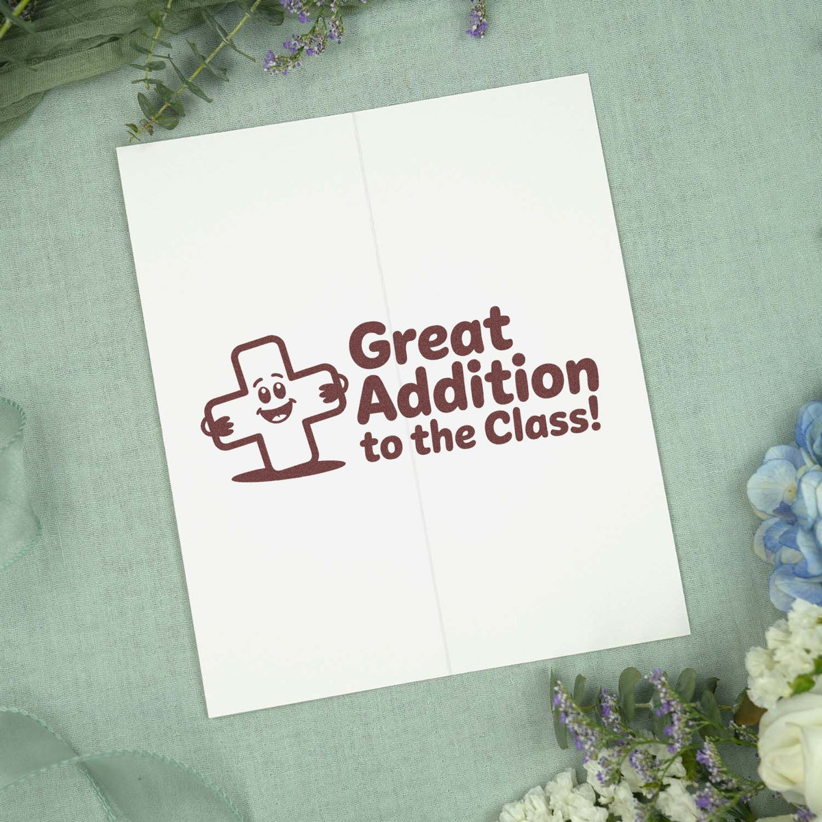 Rubber stamp design reading Great Addition to the Class! with a smiling plus sign for teacher and classroom rewards.