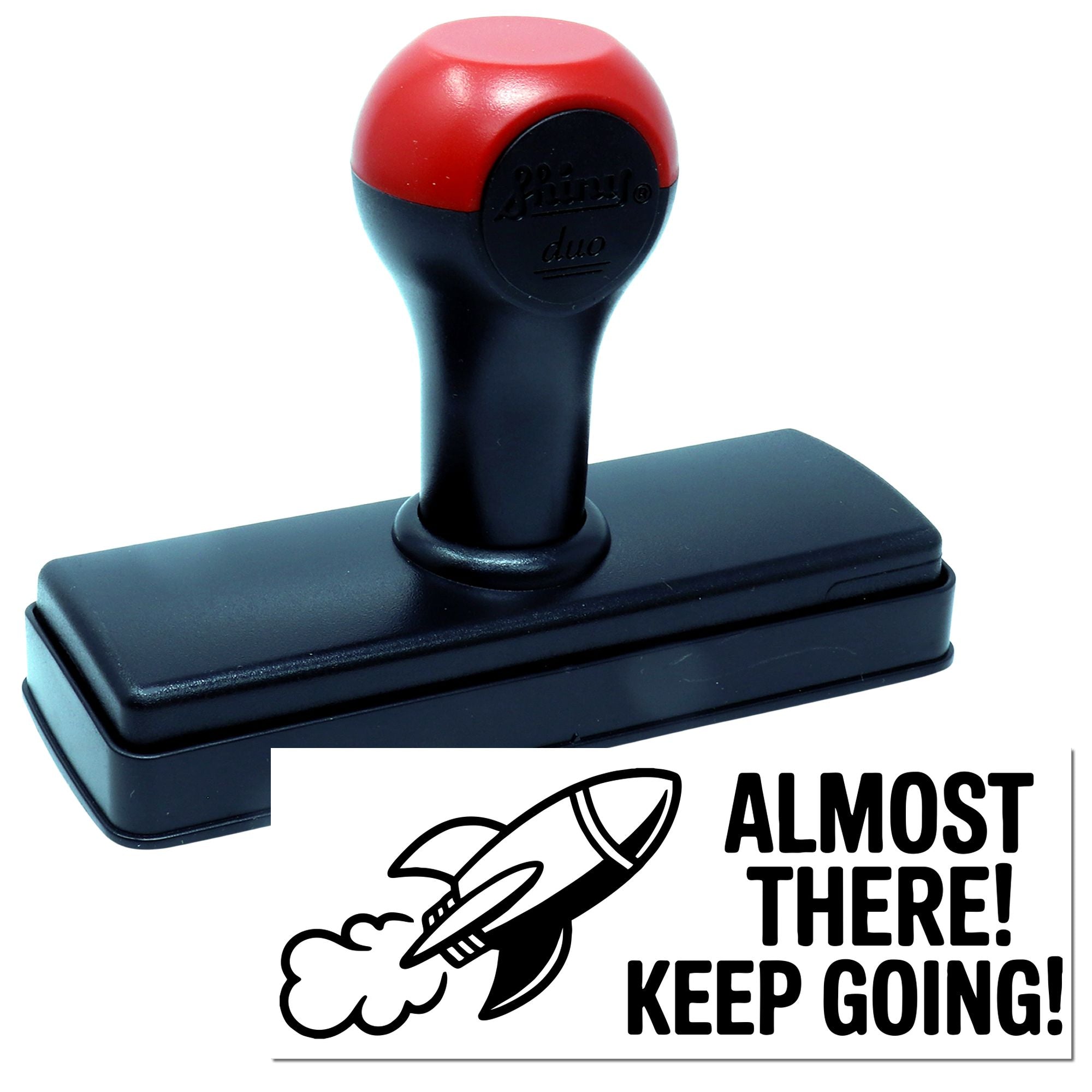 Motivational self-inking rubber stamp with rocket icon and Almost There! Keep Going! message.