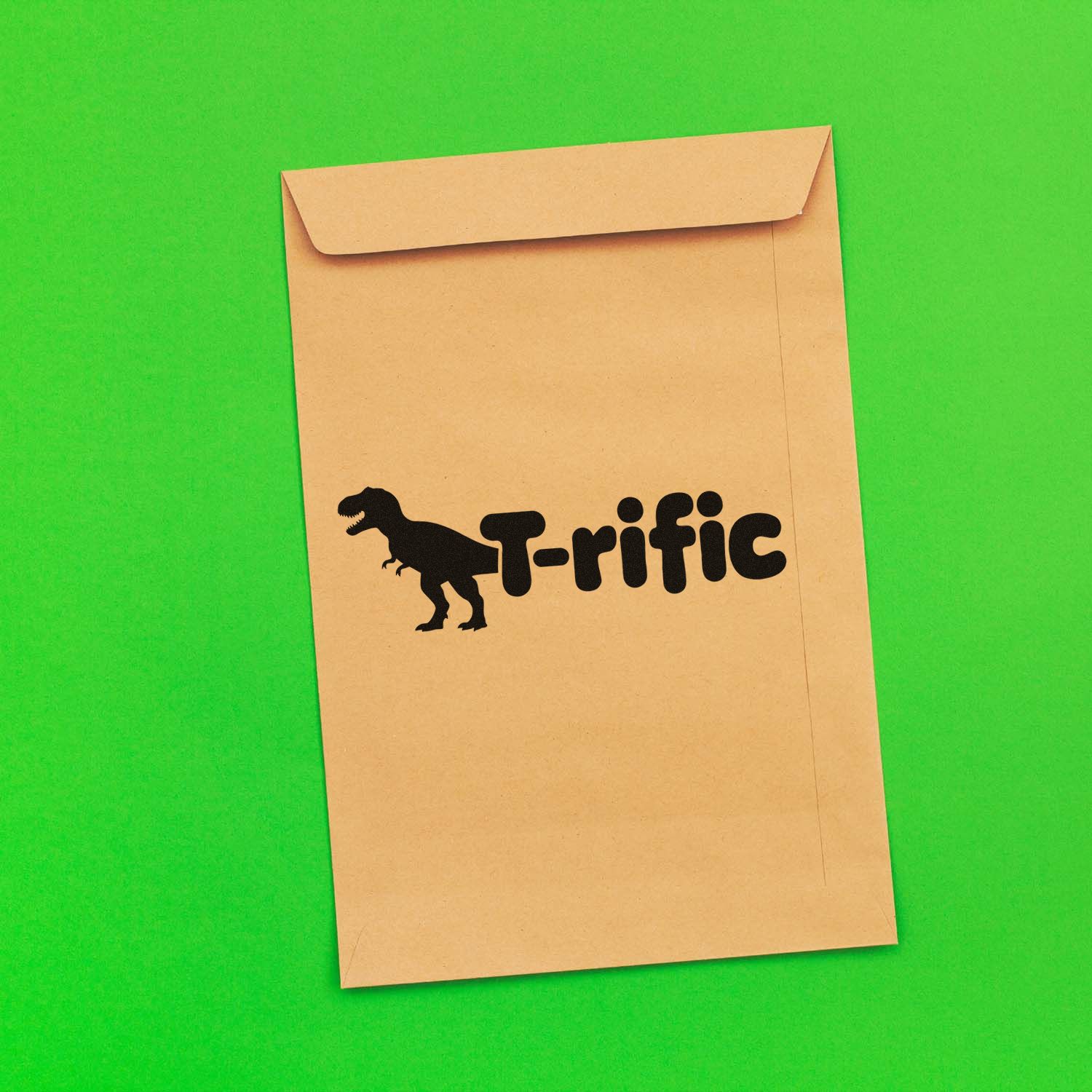 Custom dinosaur T-rific rubber stamp design on tan envelope for playful packaging and mailings.