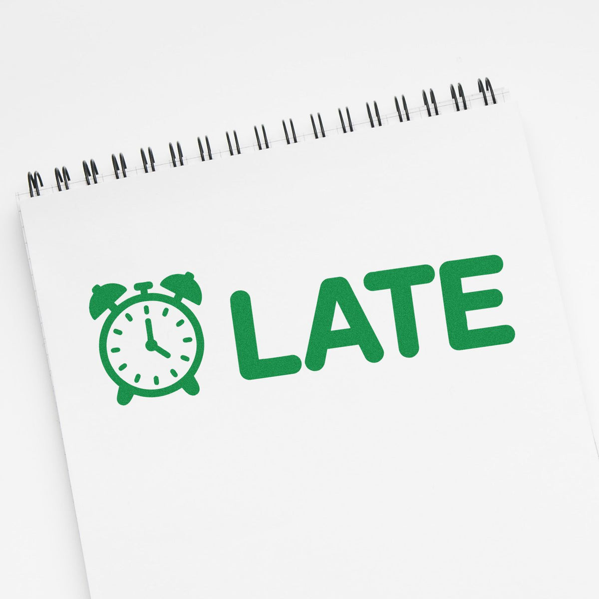 Green LATE rubber stamp with alarm clock icon, ideal for marking tardiness on office or school paperwork.