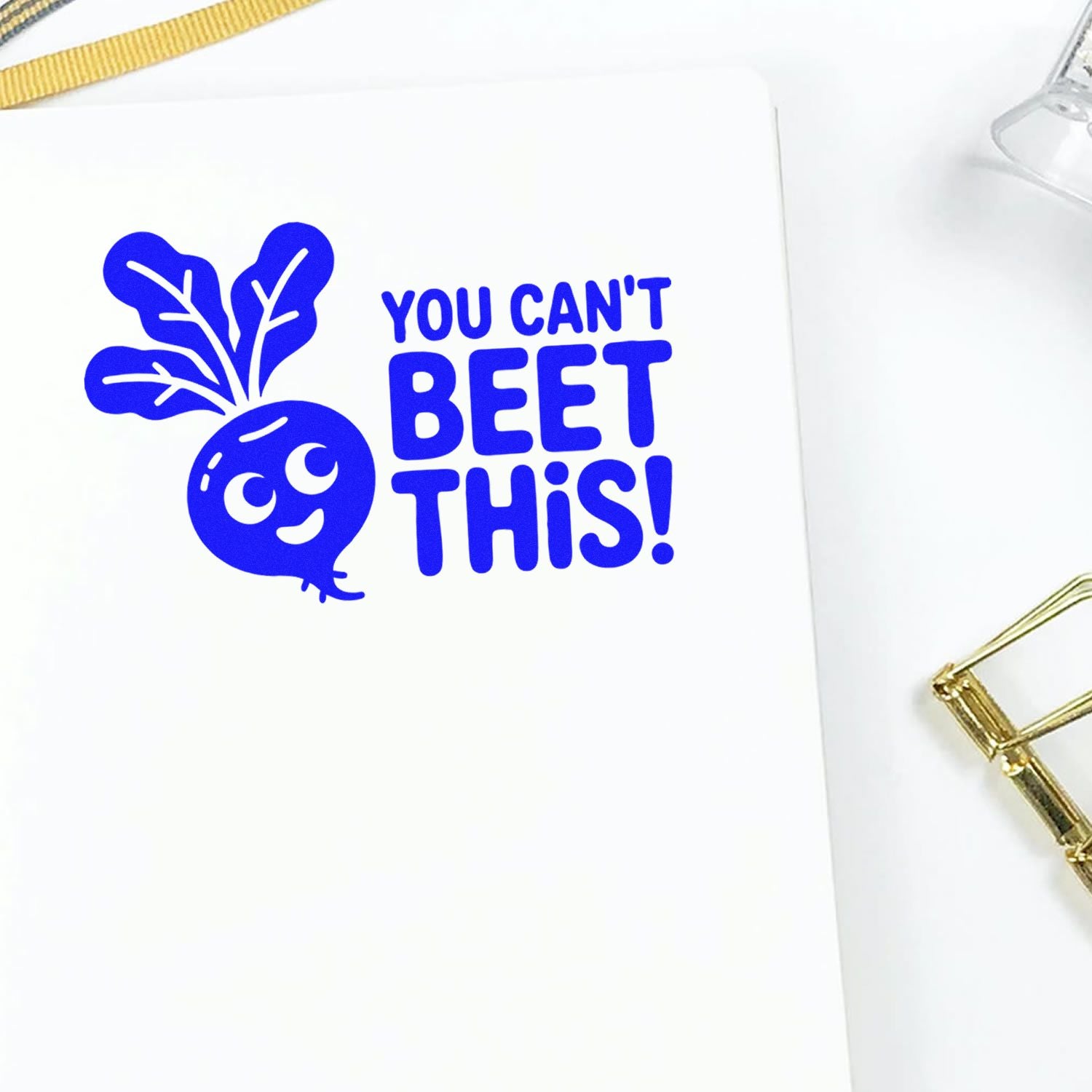Blue rubber stamp design with a beet illustration and You cant beet this! slogan on white paper.